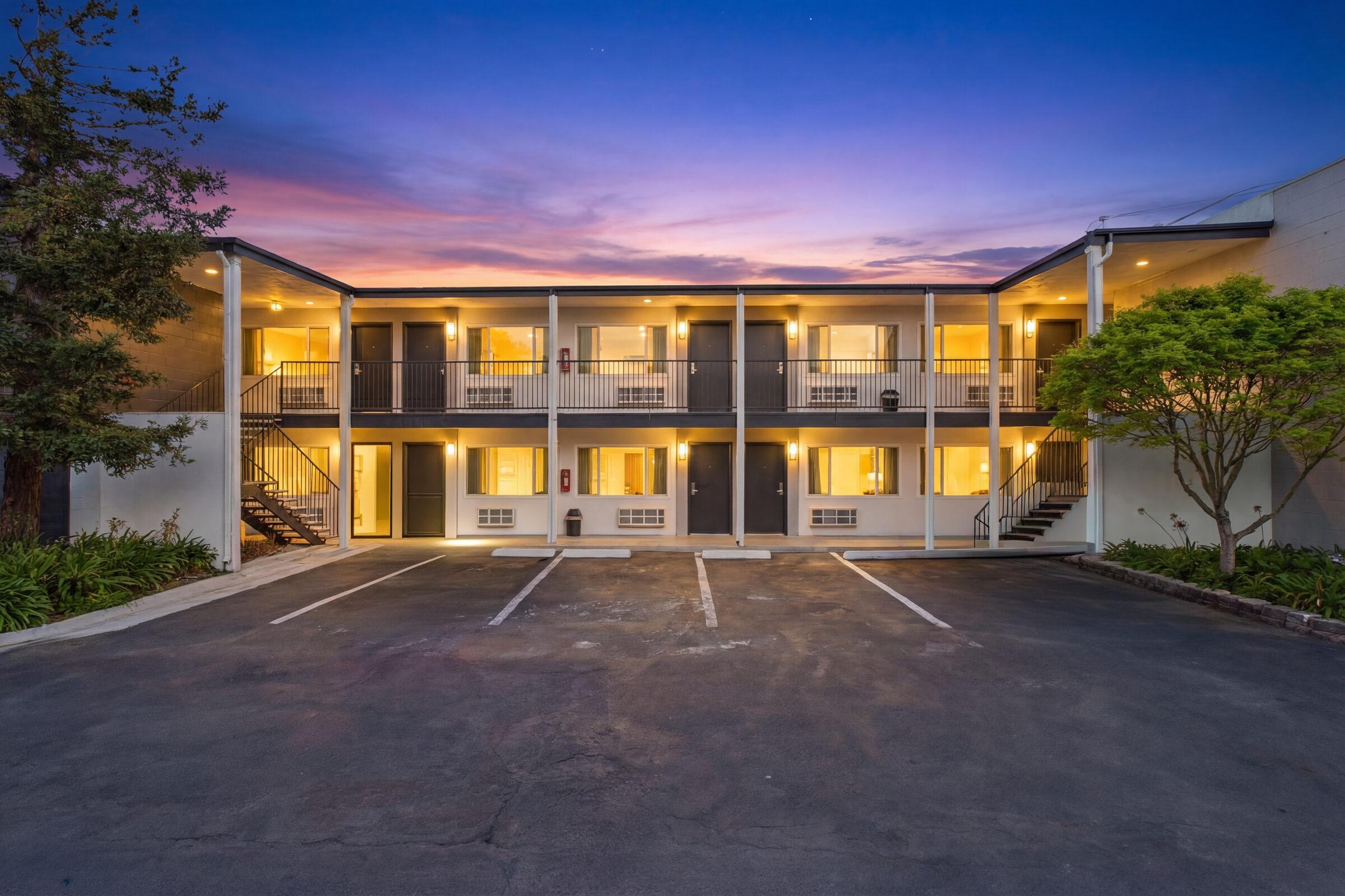 The Snoozzz Inn at dusk with the rooms lit